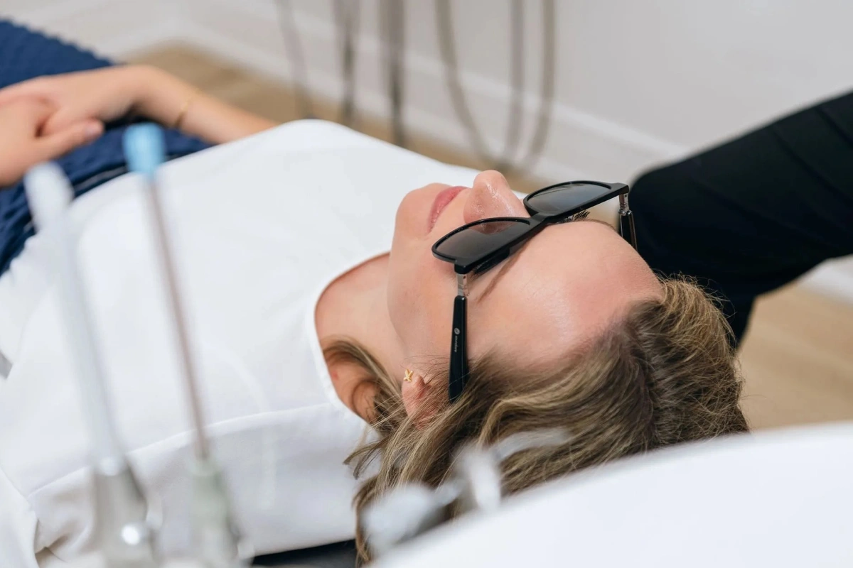 Relaxed patient wearing sunglasses while reclining in dental chair as part of the comfort menu experience at Seven Bridges Dental Studio in Woodridge, IL