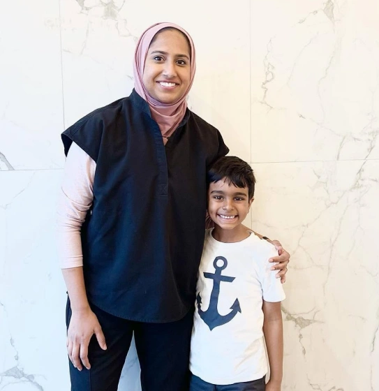 Dentist smiling with a young patient after pediatric dental sealants treatment