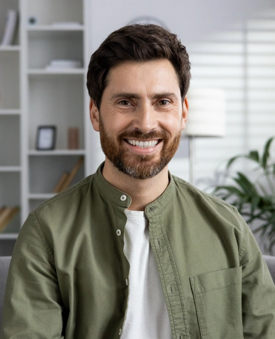 Smiling male patient with healthy teeth after full mouth reconstruction treatment