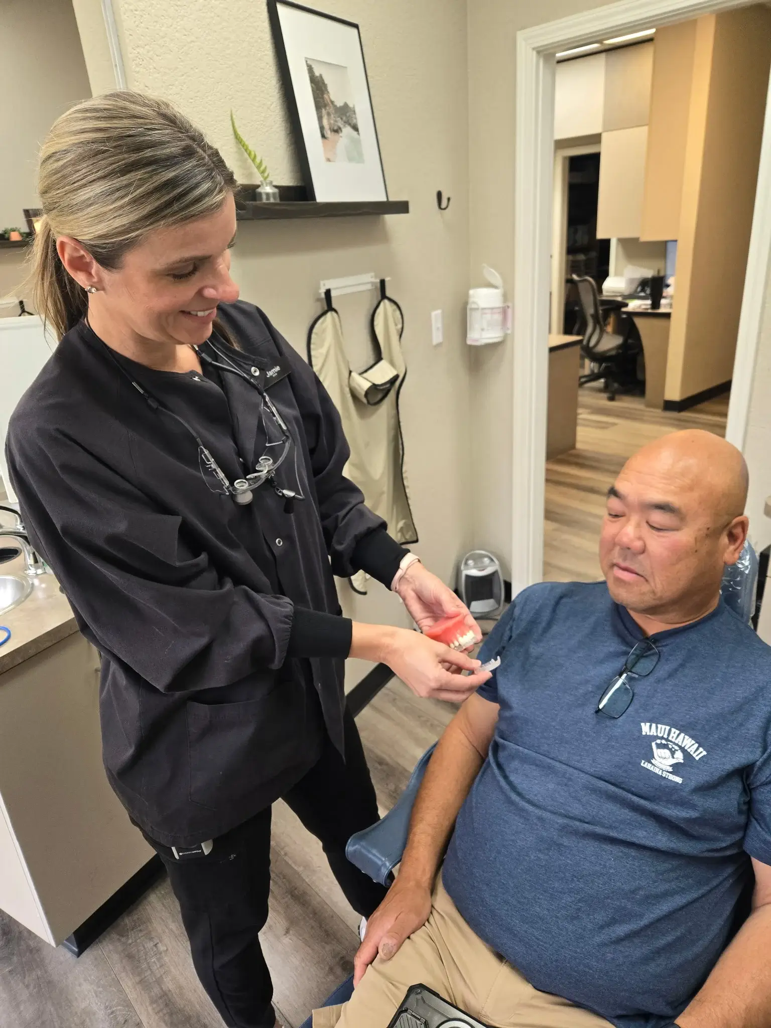 A dental team member showing a patient an oral appliance model during a consultation at Discover Airway and Sleep