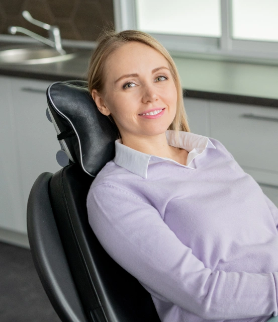 Patient smiling in a dental chair before a professional dental cleaning at South Arlington Smiles in Arlington, TX.
