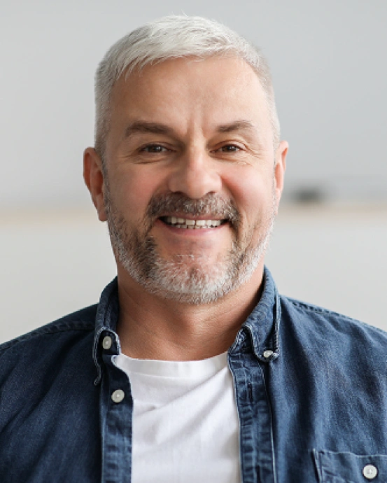 Smiling patient showcasing the natural-looking results and confidence restored with dental implants at South Arlington Smiles in Arlington, TX.