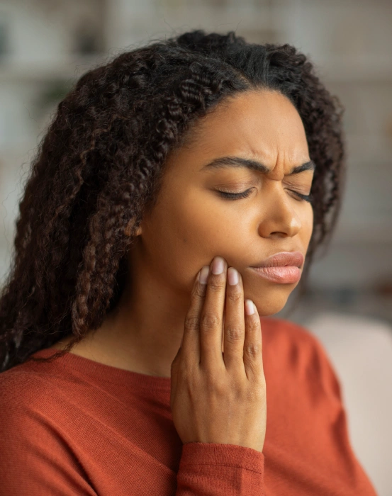 A patient experiencing a dental emergency and jaw pain, highlighting fast, reliable emergency dental care.