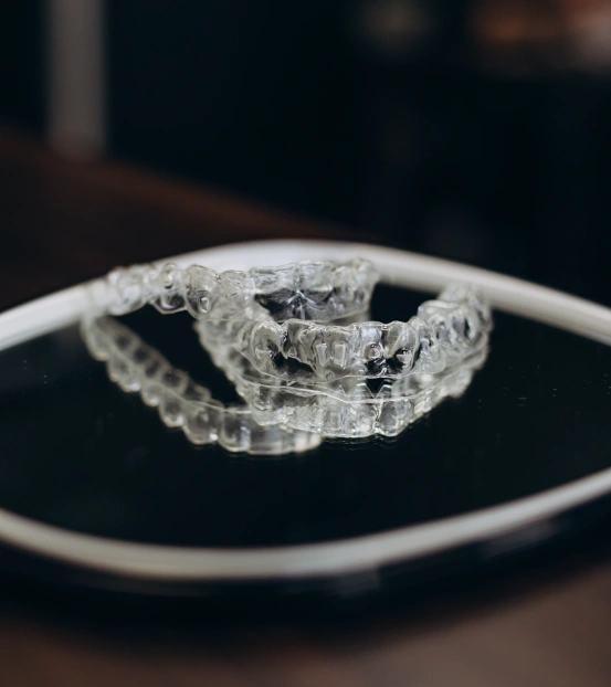 Clear Invisalign® aligners in a protective case for discreet teeth straightening at South Arlington Smiles in Arlington, TX.