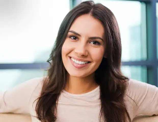 woman smiling brightly after teeth whitening treatment at Thrive Family Dentistry of Auburn in Auburn, AL