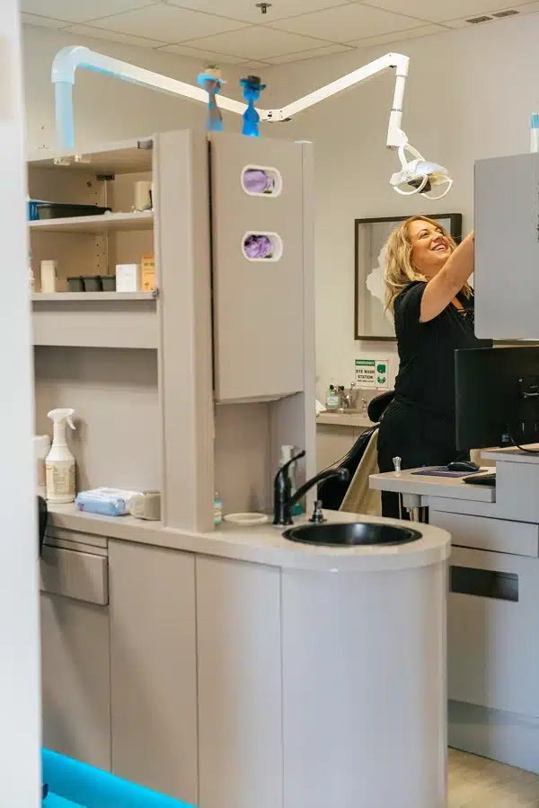 Dental hygienist preparing treatment room at TRU Dentistry SoCo in South Austin, TX