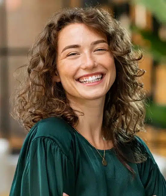 Woman smiling confidently after cosmetic dentistry treatment at TRU Dentistry SoCo in South Austin, TX