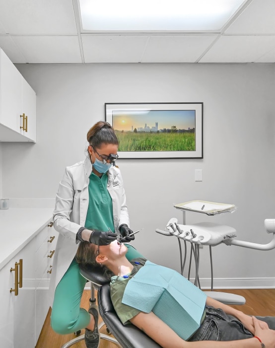 Dr. Hotic examining a patient at her dental office in Charlotte, NC