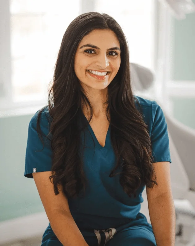 Dr. Anum Zaidi smiling in her Clarksburg dental office