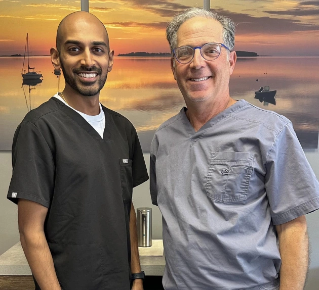 Dr. Jay Patel smiling with a patient at Vibrant Smiles of Holland in Holland, PA