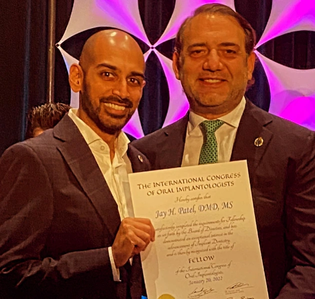 Dr. Jay Patel receiving his Fellowship certificate from the International Congress of Oral Implantologists