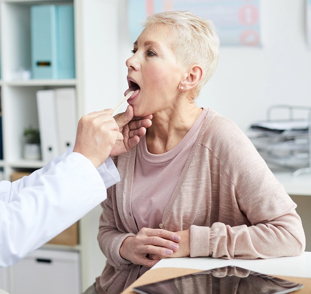 Patient receiving an oral cancer screening during a preventive dental visit