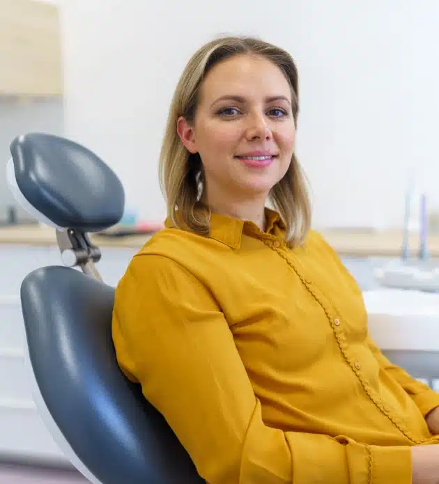 Patient seated comfortably in a dental chair during a routine dental cleaning and exam