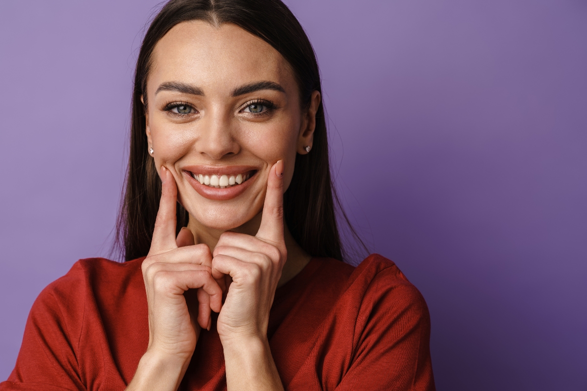 Patient showing a brighter smile after dental stain removal treatment