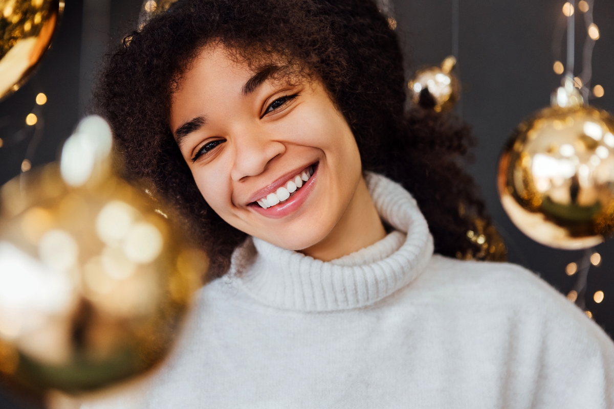Woman smiling after teeth whitening with crowns, veneers, or fillings