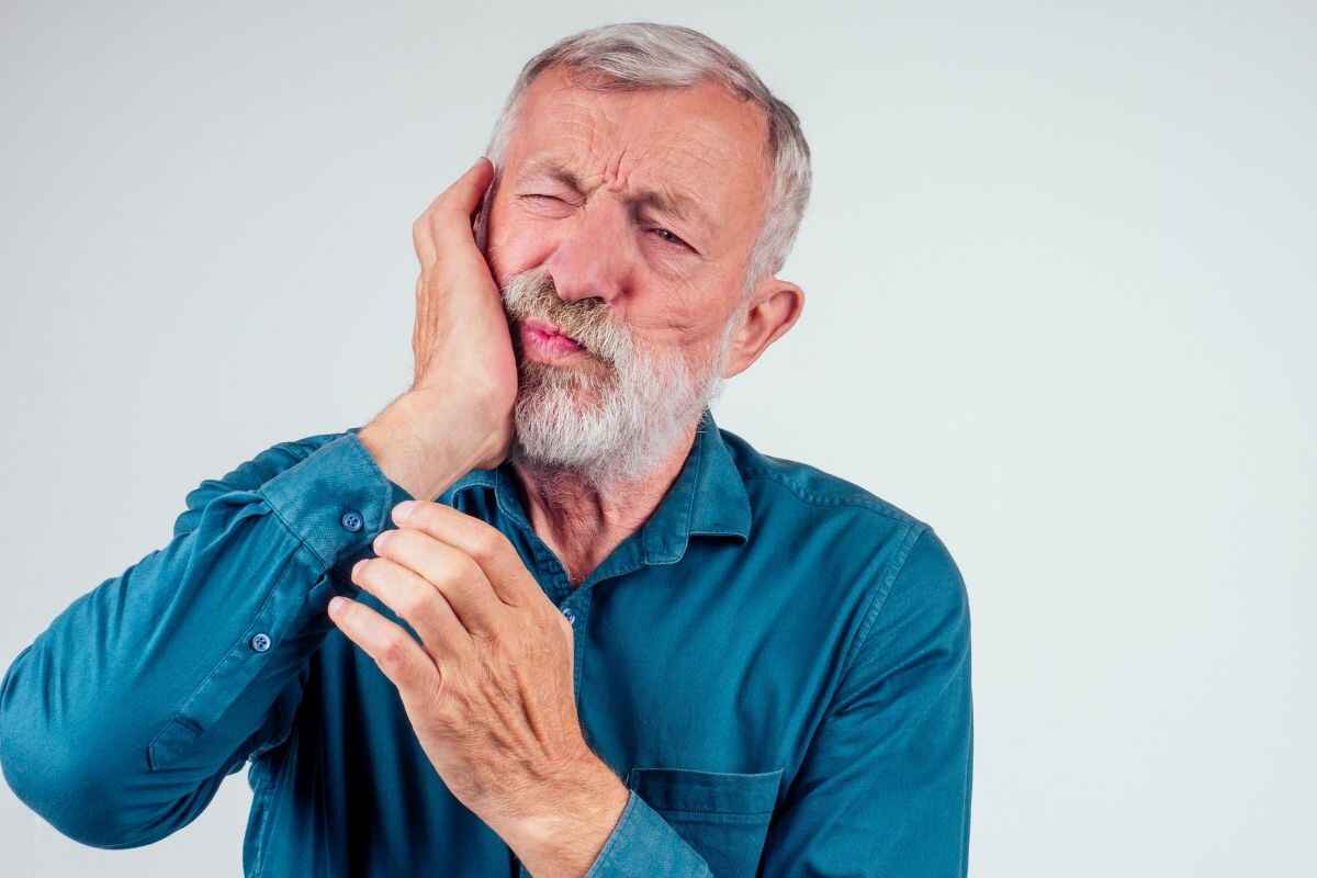 man experiencing deep pain in teeth for sudden emergency strike