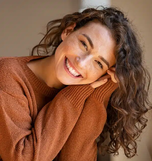 Woman smiling brightly after cosmetic dental treatment at Willow Street Dental in Chippewa Falls, WI