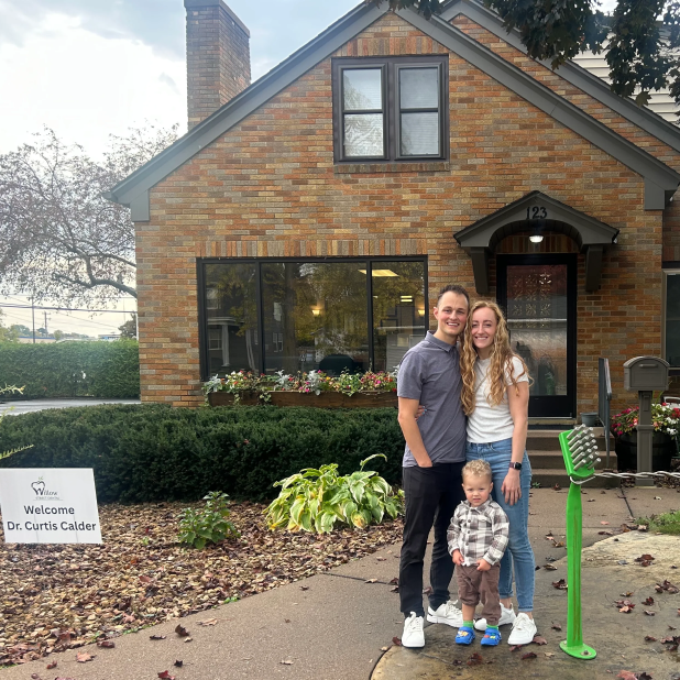 Dr. Curtis Calder with his family standing outside Willow Street Dental