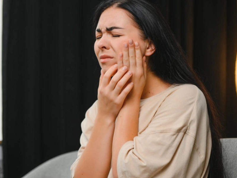 A woman with TMJ disorder. Causes of TMJ & TMD - The Woodlands, TX - Dentistry and Orthodontics