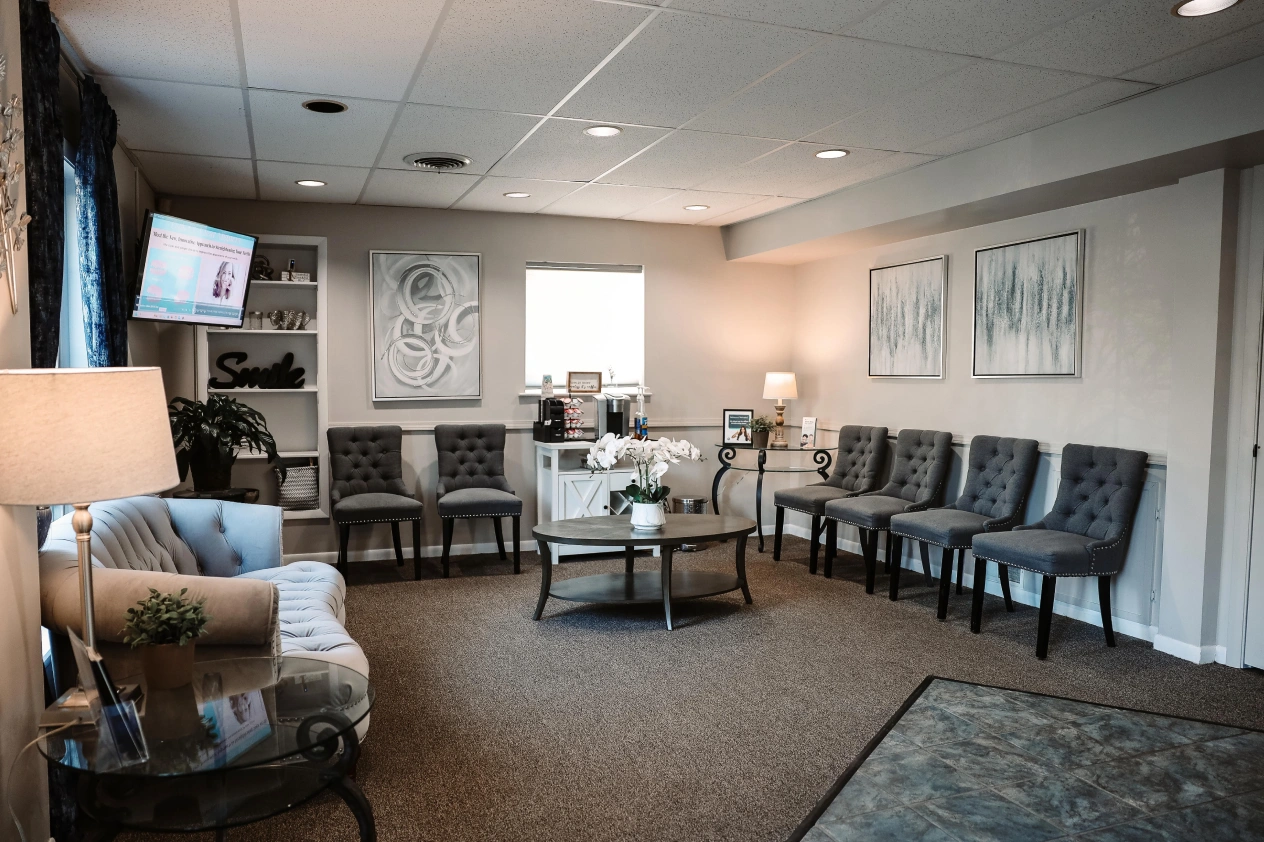 Modern dental practice waiting room with comfortable seating and professional decor in Aurora, IL.