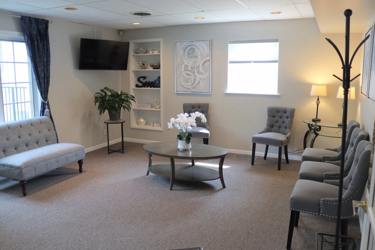 Modern dental practice waiting room with comfortable seating and calming decor in Batavia, Illinois.