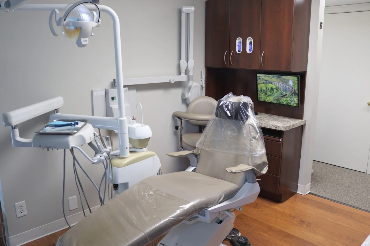 Modern dental treatment room in North Aurora, IL with chair, equipment, and patient amenities.